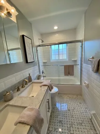 a bathroom with a sink a toilet and bathtub