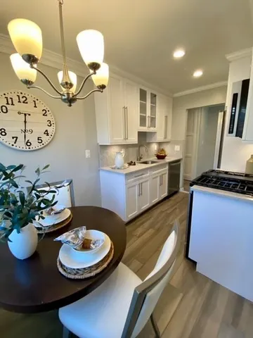 a kitchen with dining table and chairs