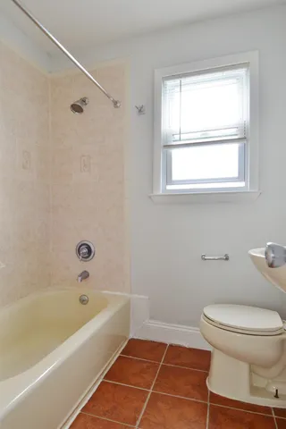 a bathroom with a toilet and a bathtub