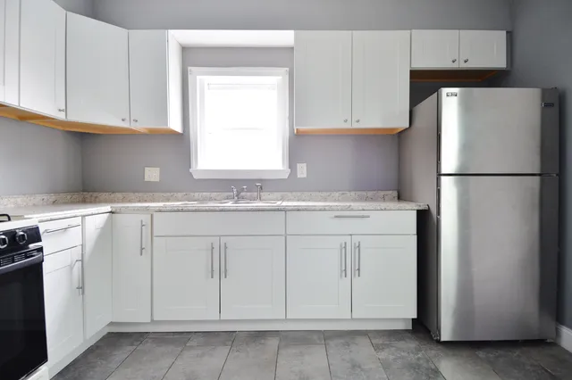 a white refrigerator freezer sitting inside of a kitchen