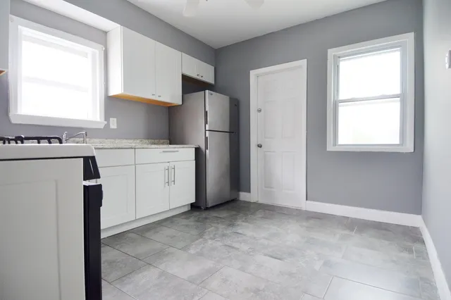 a kitchen with a stove a sink and a refrigerator