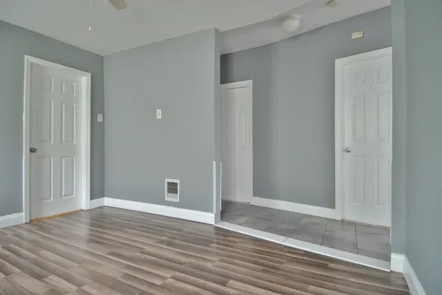a view of an empty room with wooden floor