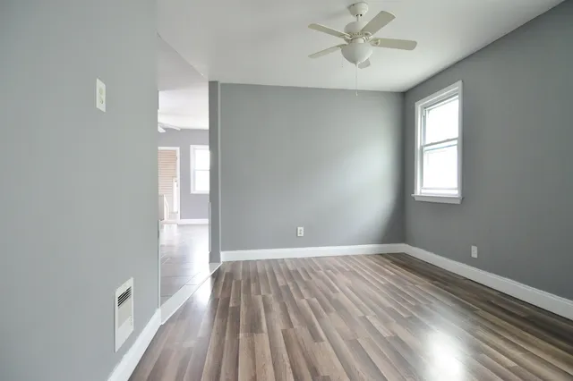 wooden floor in an empty room with a window