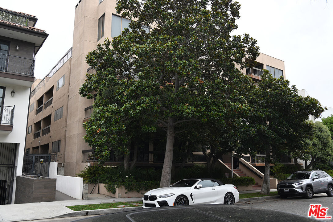 a view of a car parked in front of a buildings