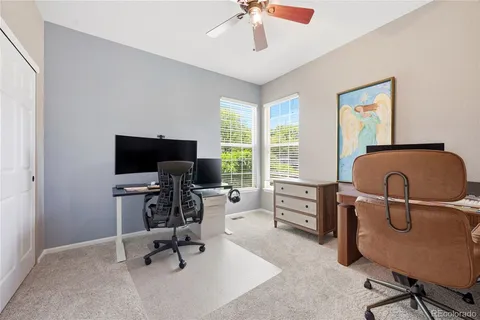 a view of a livingroom with workspace and a window
