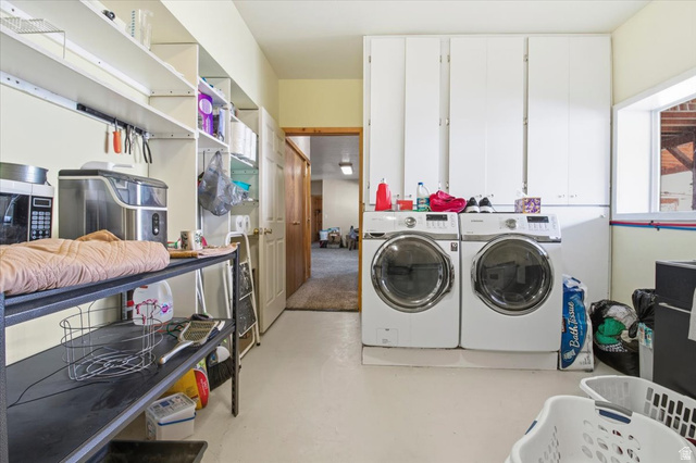 811 East Canyon Road Mayfield, UT 84643 - Photo 36 of 57 Dedicated laundry space featuring a side-by-side washer and dryer set, white cabinetry, open shelving, a built-in countertop, and a window providing natural light