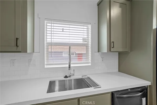 a kitchen with a sink and a window