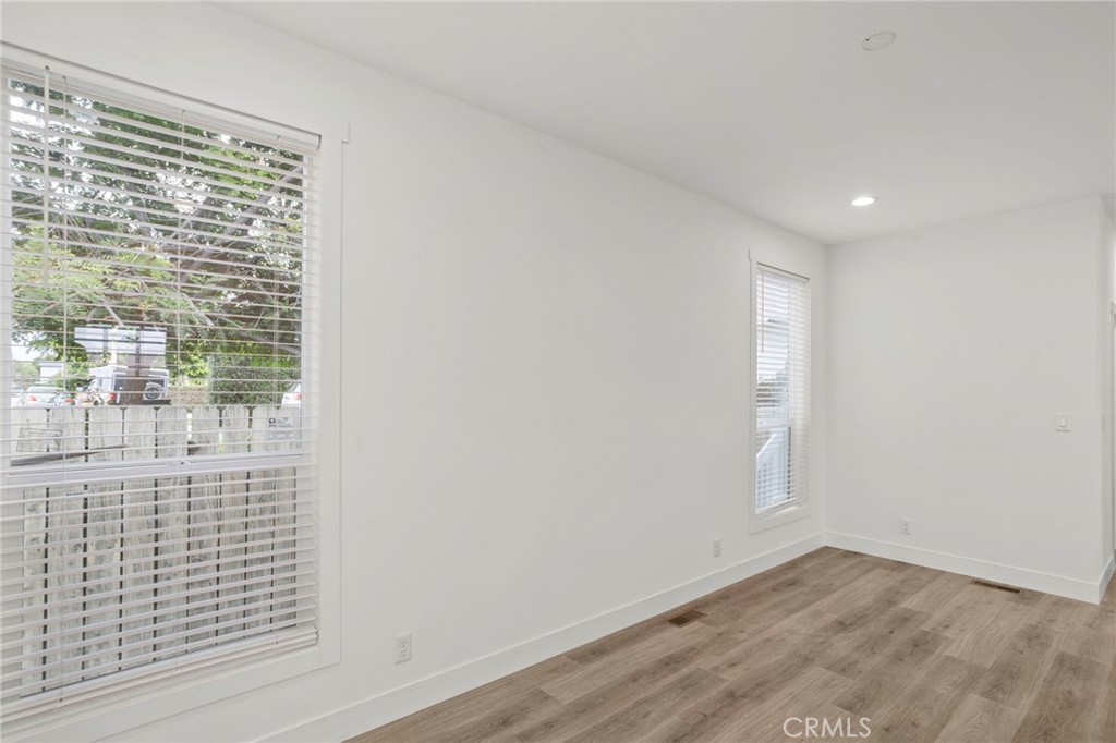 2548 Peck Road, Unit 39 Monrovia, CA 91016 - Photo 2 of 26 an empty room with wooden floor and windows