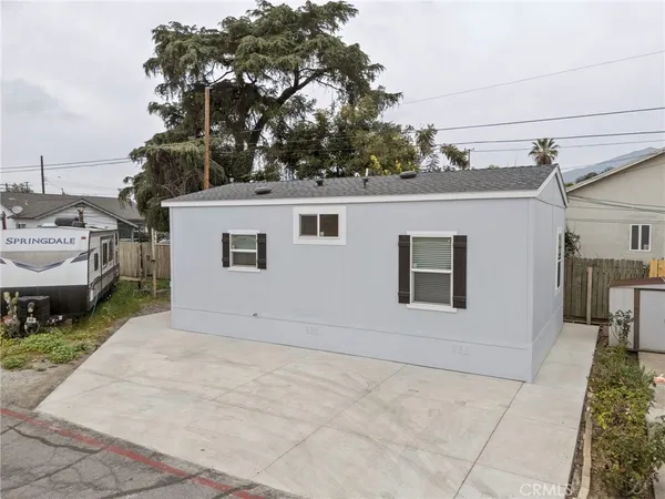 an aerial view of a house with garden space and seating area