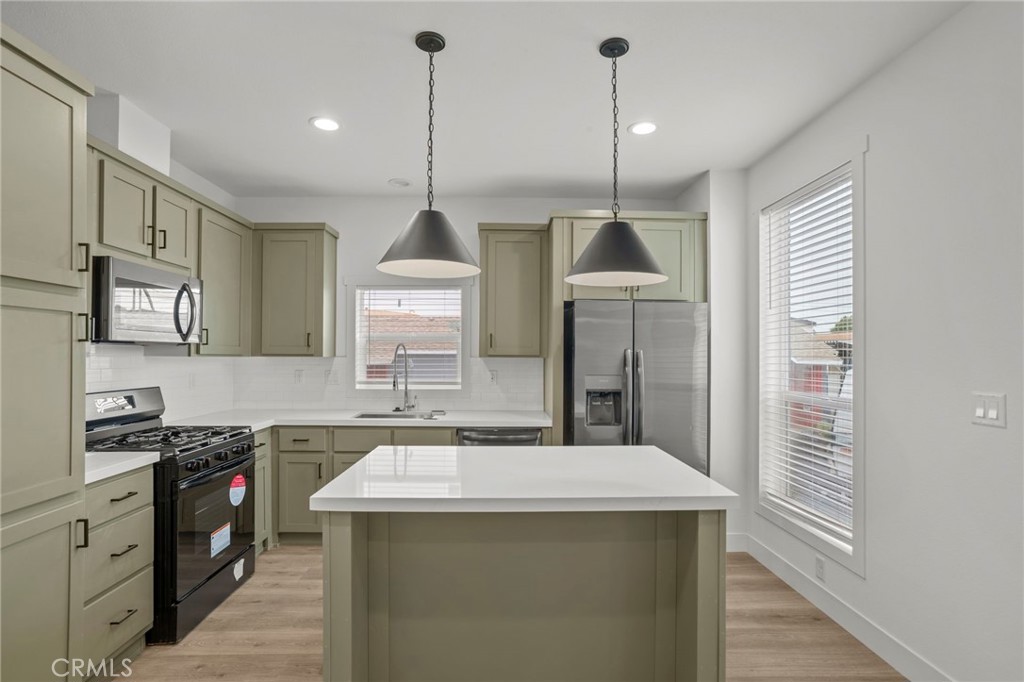 2548 Peck Road, Unit 39 Monrovia, CA 91016 - Photo 8 of 26 a kitchen with stainless steel appliances granite countertop a sink a stove and a wooden floors