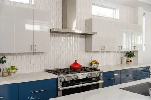a kitchen with a sink a counter top space and appliances