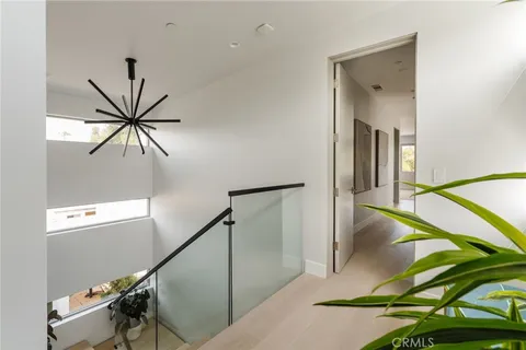 a bedroom with a bed and windows