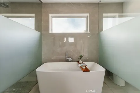 a bedroom with a bed a potted plant on a dresser and a potted plant