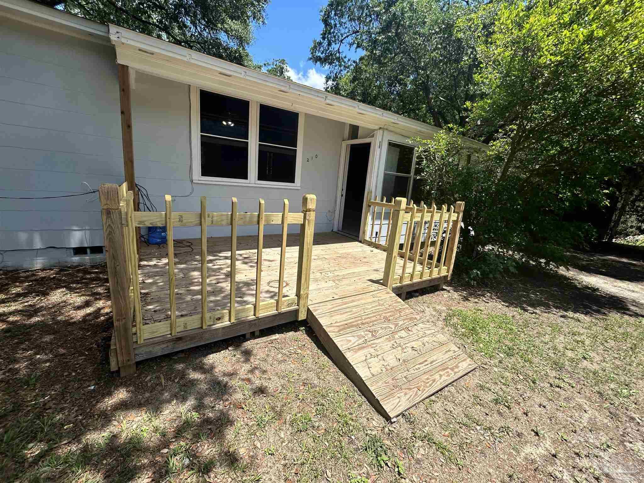 210 Milton Road Pensacola, FL 32507 - Photo 2 of 17 a view of a house with backyard and sitting area