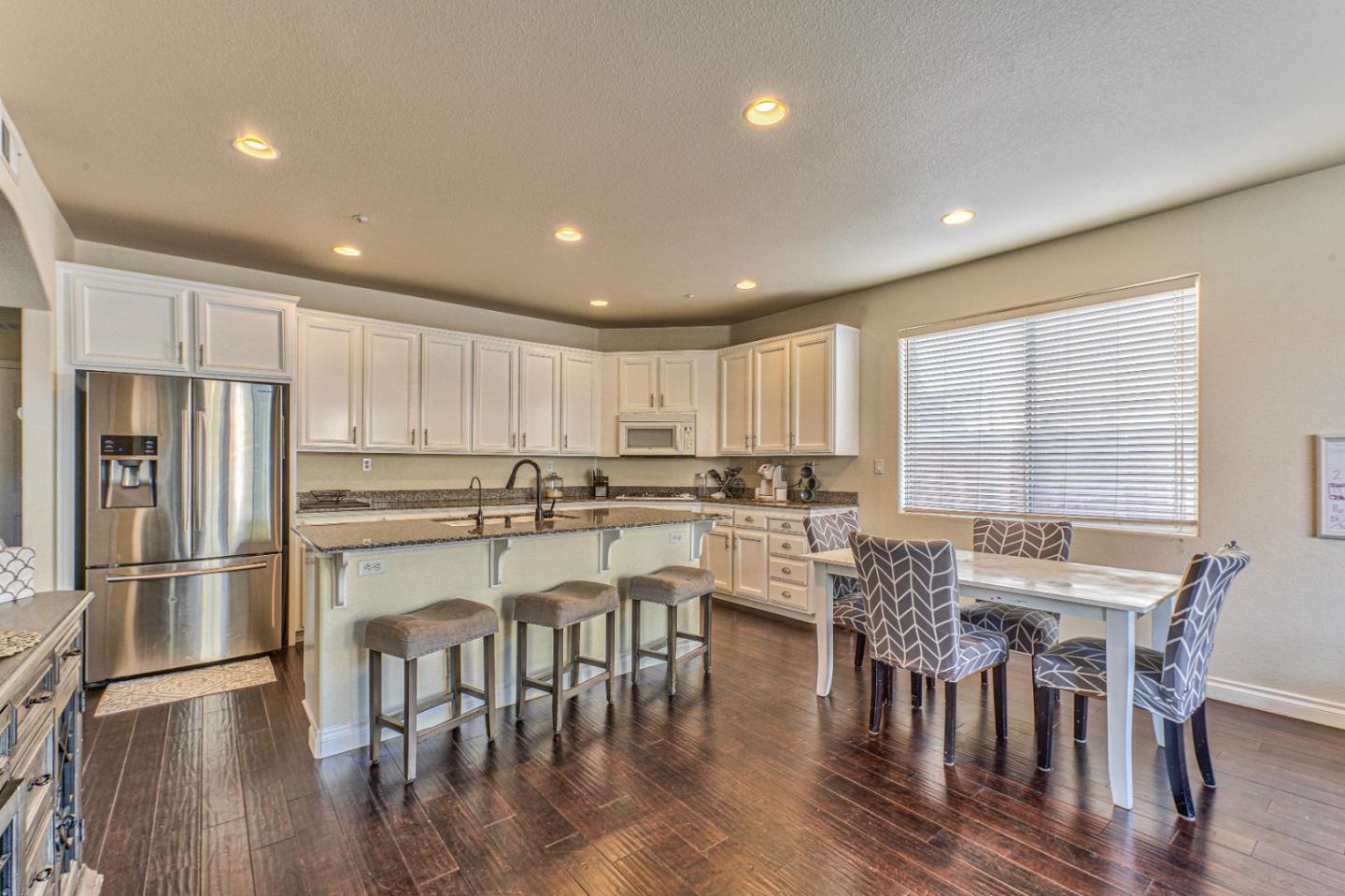 10 Whitman Circle Salinas, CA 93906 - Photo 15 of 33 a kitchen with a table and chairs stainless steel appliances with wooden floor