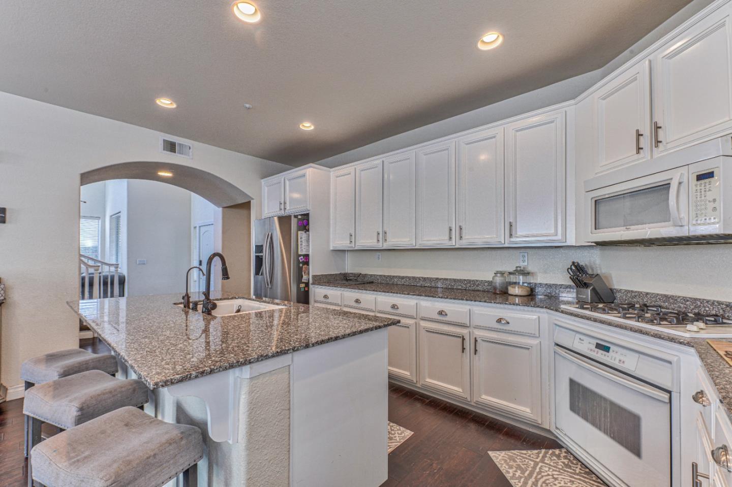 10 Whitman Circle Salinas, CA 93906 - Photo 16 of 33 a kitchen with granite countertop a sink a stove and cabinets