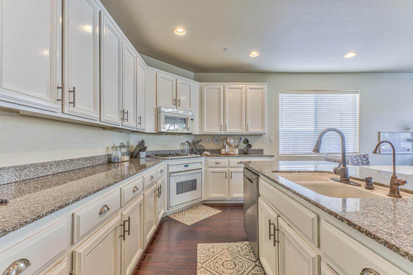 10 Whitman Circle Salinas, CA 93906 - Photo 17 of 33 a kitchen with granite countertop white cabinets white stainless steel appliances and sink