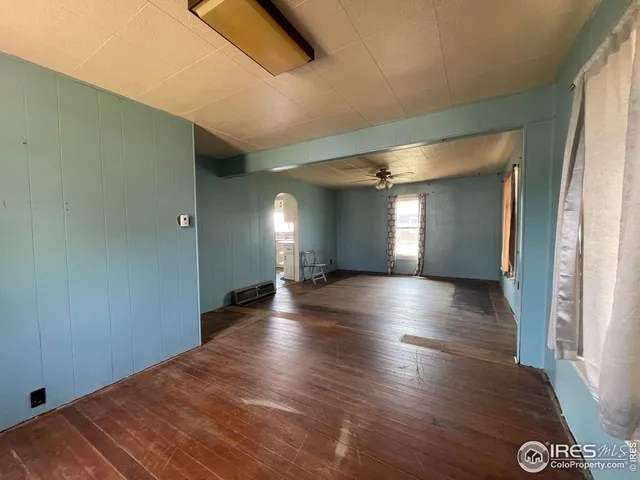 a view of a room with window and wooden floor