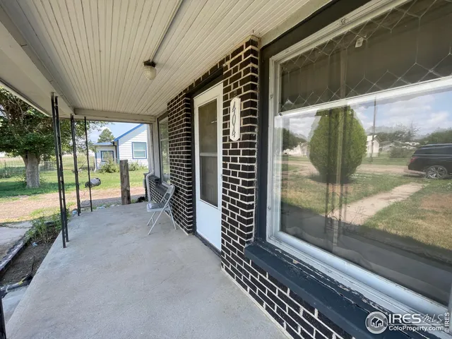 a backyard of a house with table and chairs
