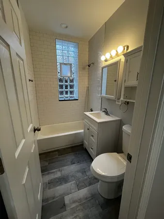 a bathroom with a sink a toilet a mirror a vanity and a shower