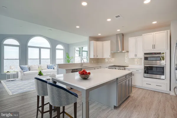 a kitchen with stainless steel appliances granite countertop a sink and a stove top oven
