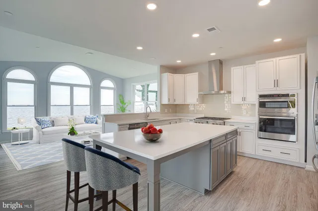 a kitchen with stainless steel appliances granite countertop a sink and a stove top oven