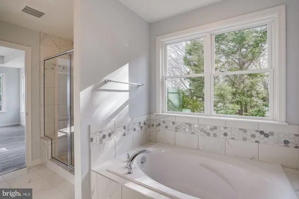 a bathroom with a glass shower door