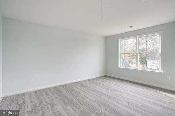 a view of an empty room and wooden floor