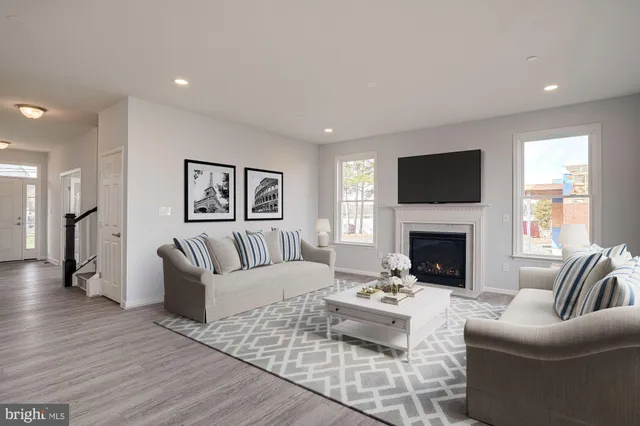 a living room with fireplace furniture and a flat screen tv