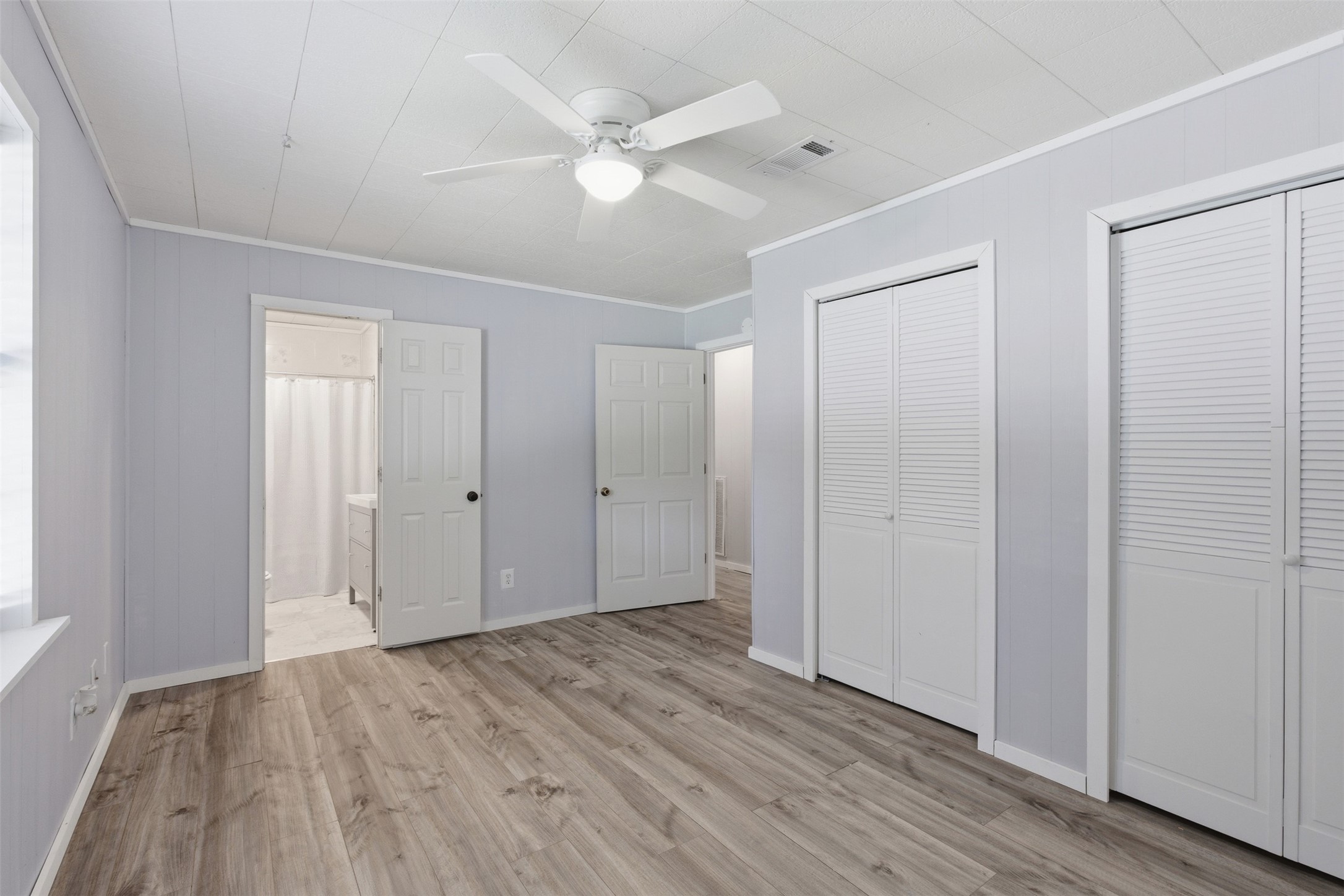 1310 Brazos Street Hempstead, TX 77445 - Photo 11 of 32 an empty room with wooden floor and windows