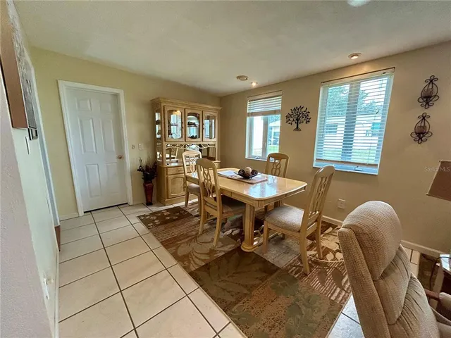 a dining room with furniture and window
