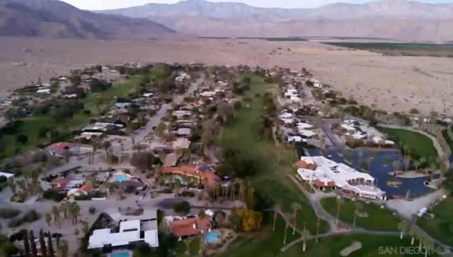 an aerial view of lake and residential houses with outdoor space