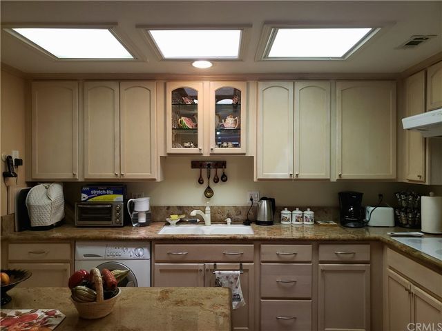 a kitchen with stainless steel appliances granite countertop a sink and cabinets