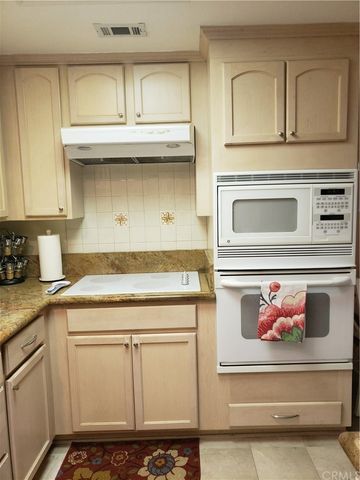 a view of a dining room with furniture a chandelier and wooden floor