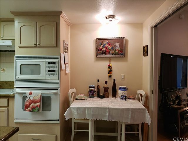 a living room with furniture and wall paintings