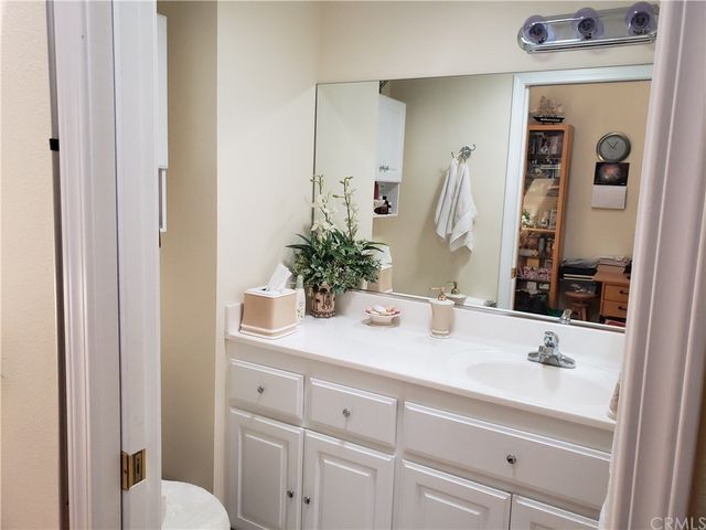 a bed sitting in a bedroom next to a window with chair