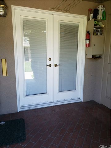 a view of a house with a yard and a tree