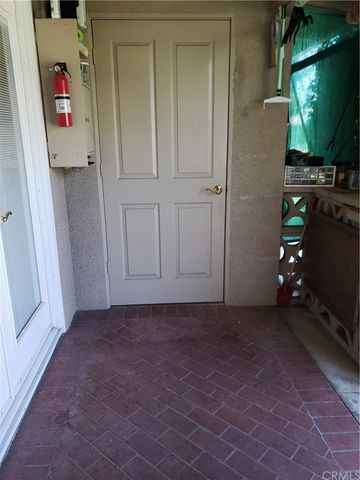 a view of a house with a big yard and potted plants and large trees