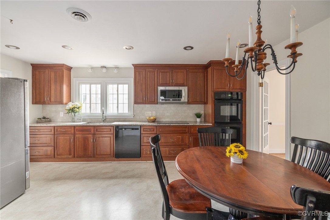 3915 Cresthill Road Chester, VA 23831 - Photo 8 of 35 a kitchen with a table chairs sink and cabinets