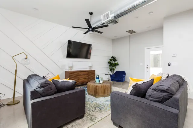 a living room with furniture and a large window