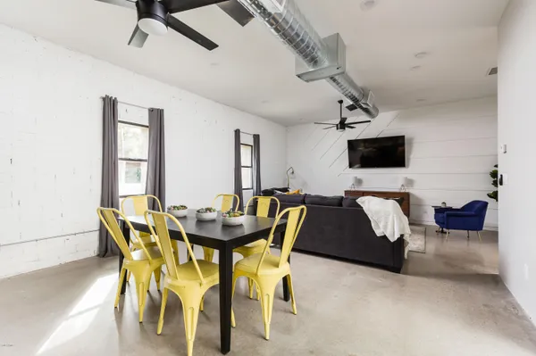 a view of a dining room with furniture and a flat screen tv