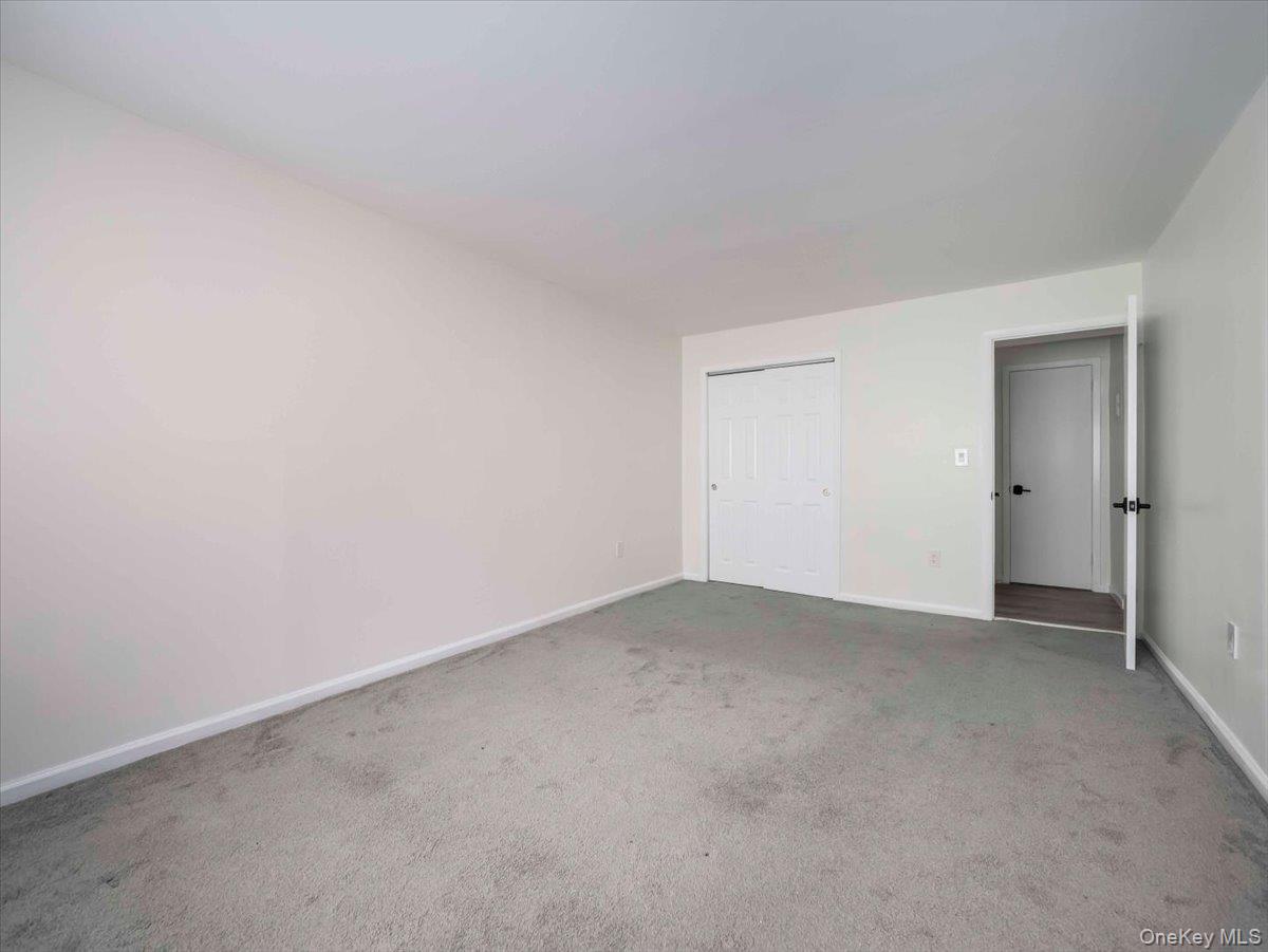 27 Tanager Road, Unit 2702 Monroe, NY 10950 - Photo 24 of 35 Spacious room featuring neutral carpeting, light-toned walls, and white baseboards
