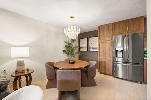 a dining room with furniture a chandelier and window
