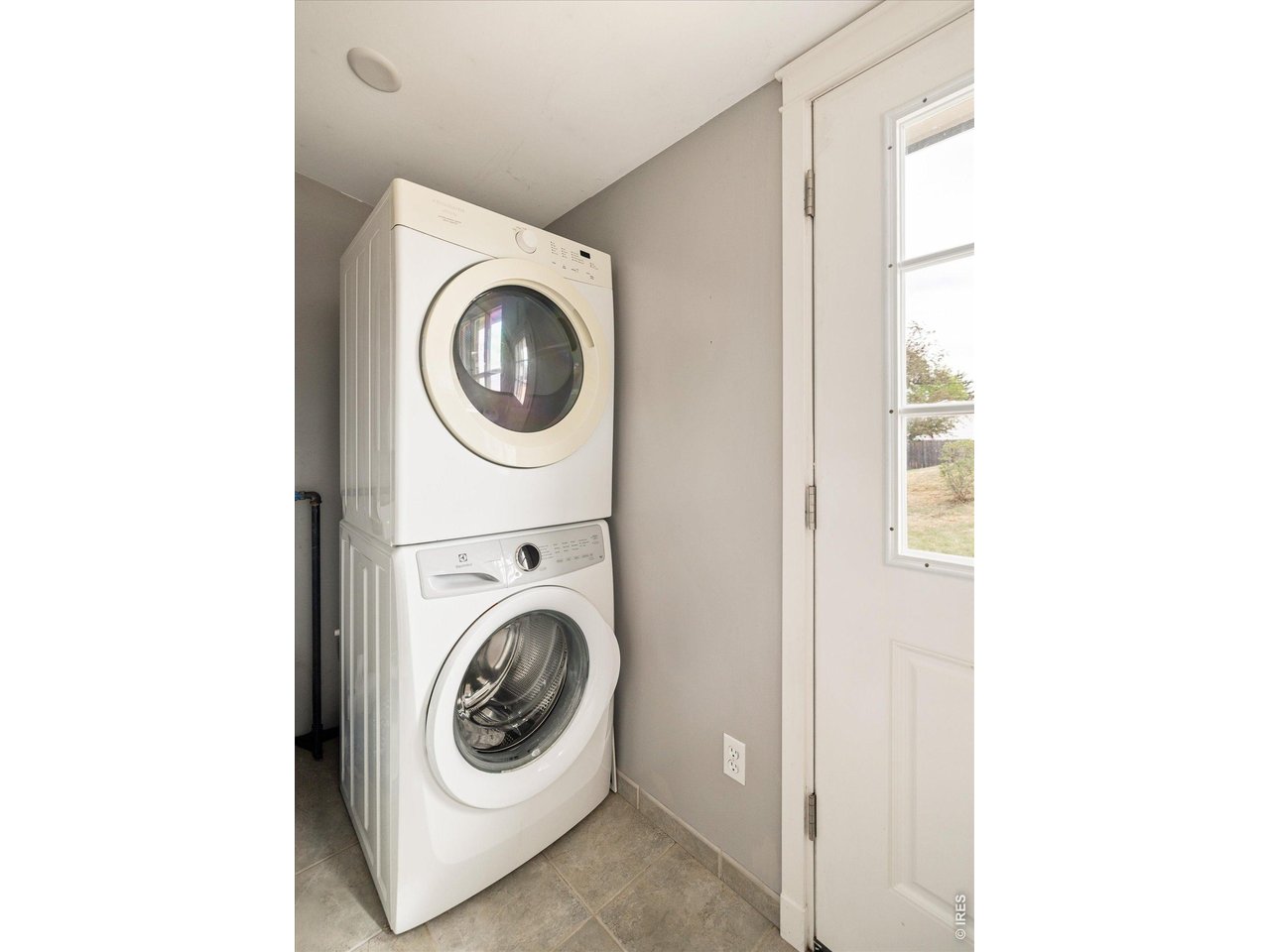 9234 Arapahoe Road Boulder, CO 80303 - Photo 23 of 37 convenient laundry area with stacked washer and dryer and direct exterior access