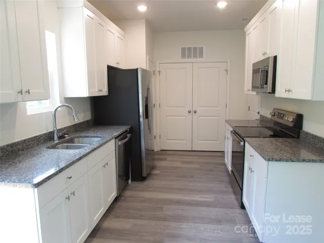 a kitchen with a sink stove and refrigerator