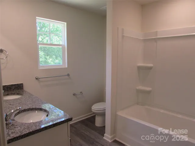 a bath room with a sink toilet and a bath tub