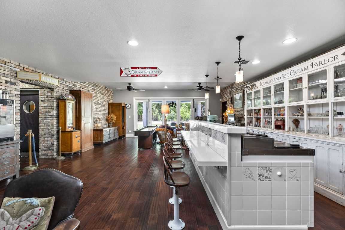999 Schwarzlose Road New Braunfels, TX 78130 - Photo 24 of 39 a view of a living room and kitchen with furniture wooden floor and chandelier
