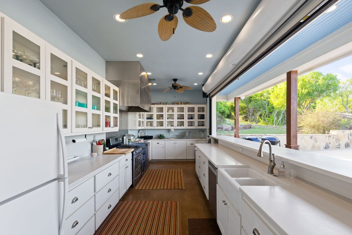 999 Schwarzlose Road New Braunfels, TX 78130 - Photo 31 of 39 a large kitchen with kitchen island a large window and a sink