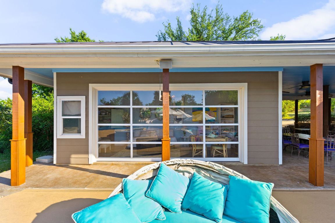 999 Schwarzlose Road New Braunfels, TX 78130 - Photo 32 of 39 a view of a house with a large window and a potted plant