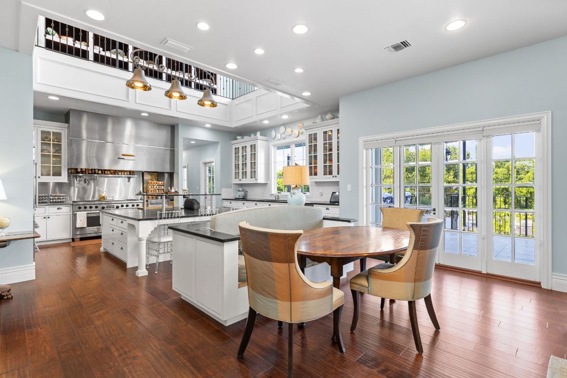 999 Schwarzlose Road New Braunfels, TX 78130 - Photo 6 of 39 a dining hall with stainless steel appliances granite countertop a stove and chairs
